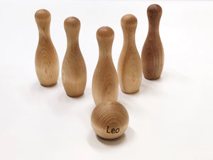 Natural wood toddler bowling set with six pins and a personalized ball engraved with the name Leo.