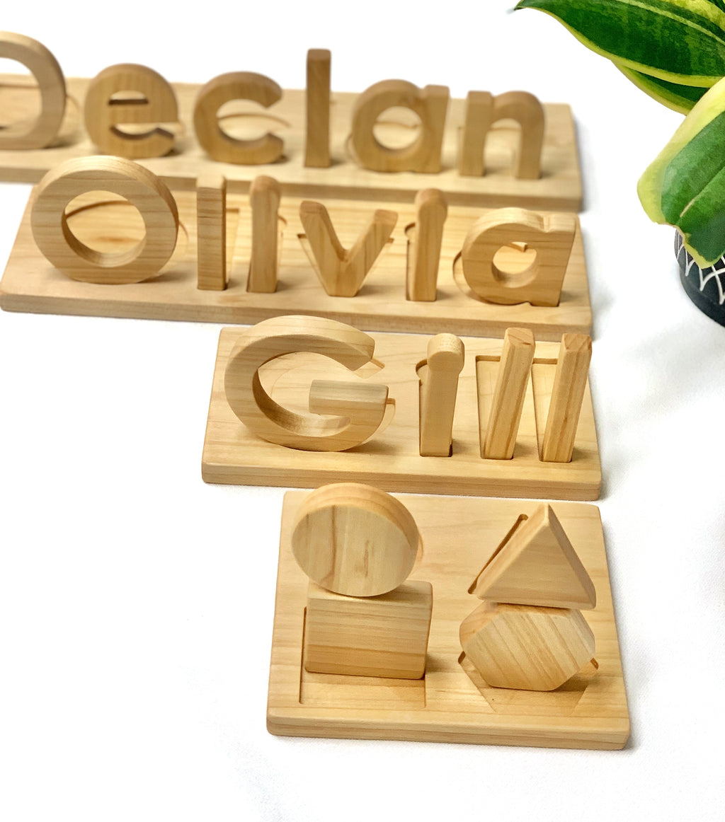 Personalized hardwood name puzzles with uppercase and lowercase letters and wooden shape sorting board on white background