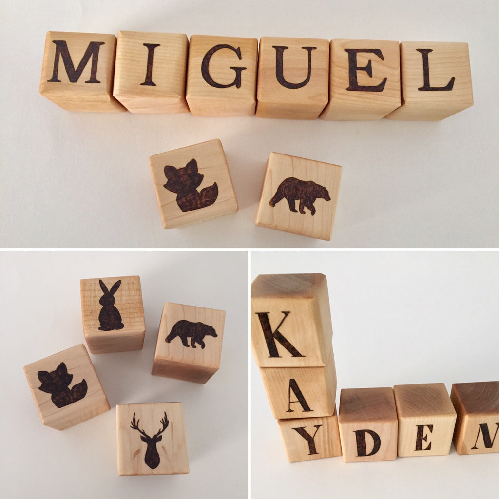 Natural 1.5 inch custom wood blocks with engraved letters spelling names and animal silhouettes on light wood background