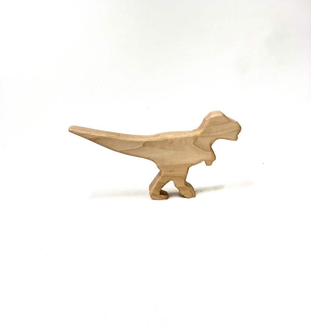 Small natural wooden T Rex dinosaur toy figurine with smooth edges on white background