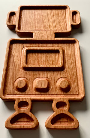 Wooden robot-shaped sensory tray with carved body, arms, legs, and screen details on a light surface