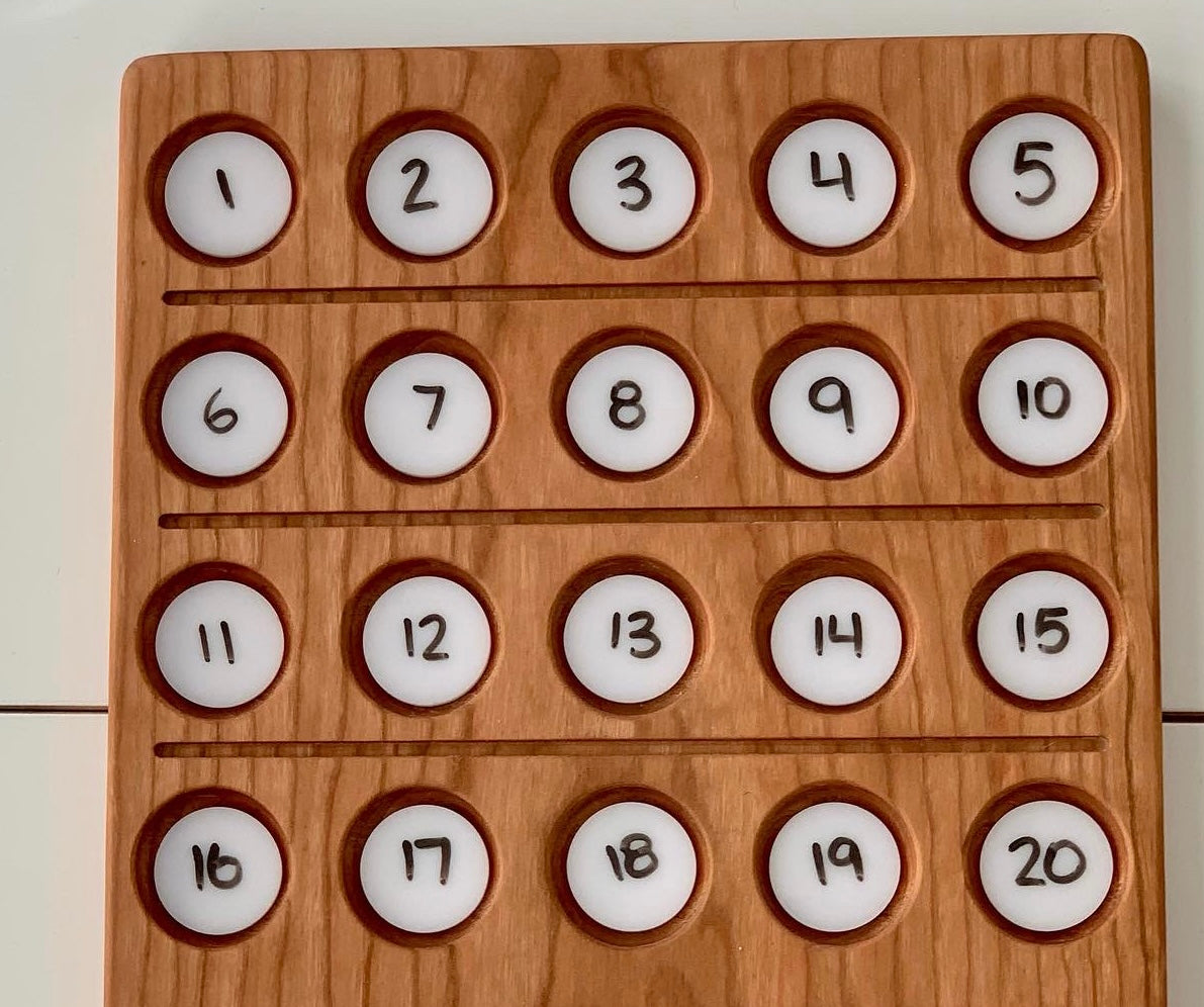 Wooden sensory tray with twenty round white dry erase circles numbered 1 to 20 arranged in rows