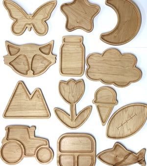 Natural wooden sensory plates shaped like butterfly, star, moon, fox, jar, cloud, mountain, flower, ice cream, tractor, and fish on white background