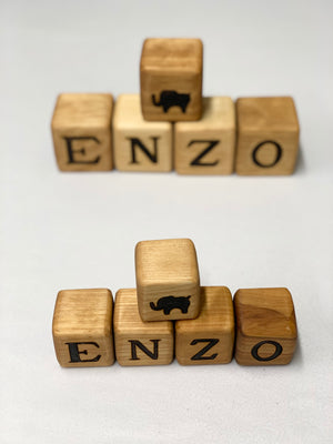 Set of personalized 2 inch custom wood blocks spelling "ENZO" with engraved animal icons on top blocks.