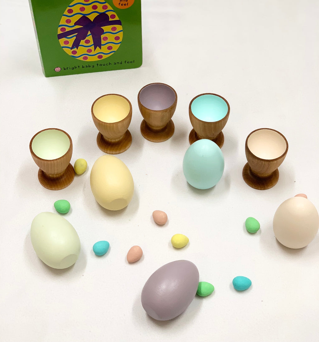 Natural wooden eggs and matching pastel-colored cups Montessori toy for color sorting and fine motor skills development