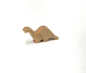 Small natural wooden dinosaur toy figurine with smooth edges on white background for imaginative play