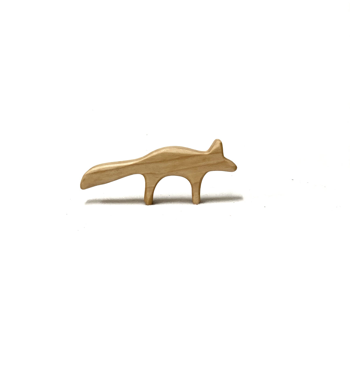 Small natural wooden fox toy figurine with smooth finish on white background