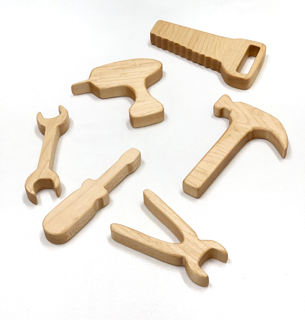 Set of six natural wooden stacking toy tools including saw, hammer, drill, screwdriver, pliers, and wrench on white background