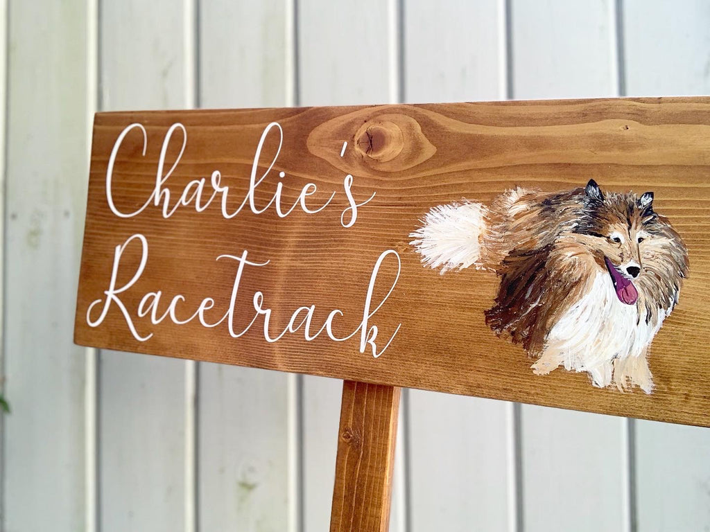 Large custom wooden garden sign with white cursive letters and hand-painted dog illustration on natural wood background