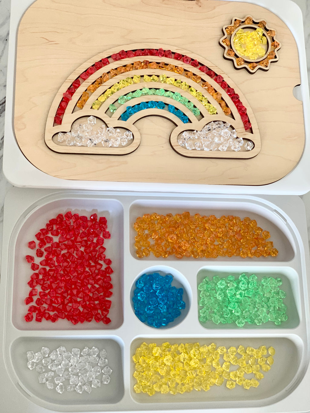 Maple plywood fillable rainbow Flisat table top insert with colorful acrylic gems in tray compartments on white surface