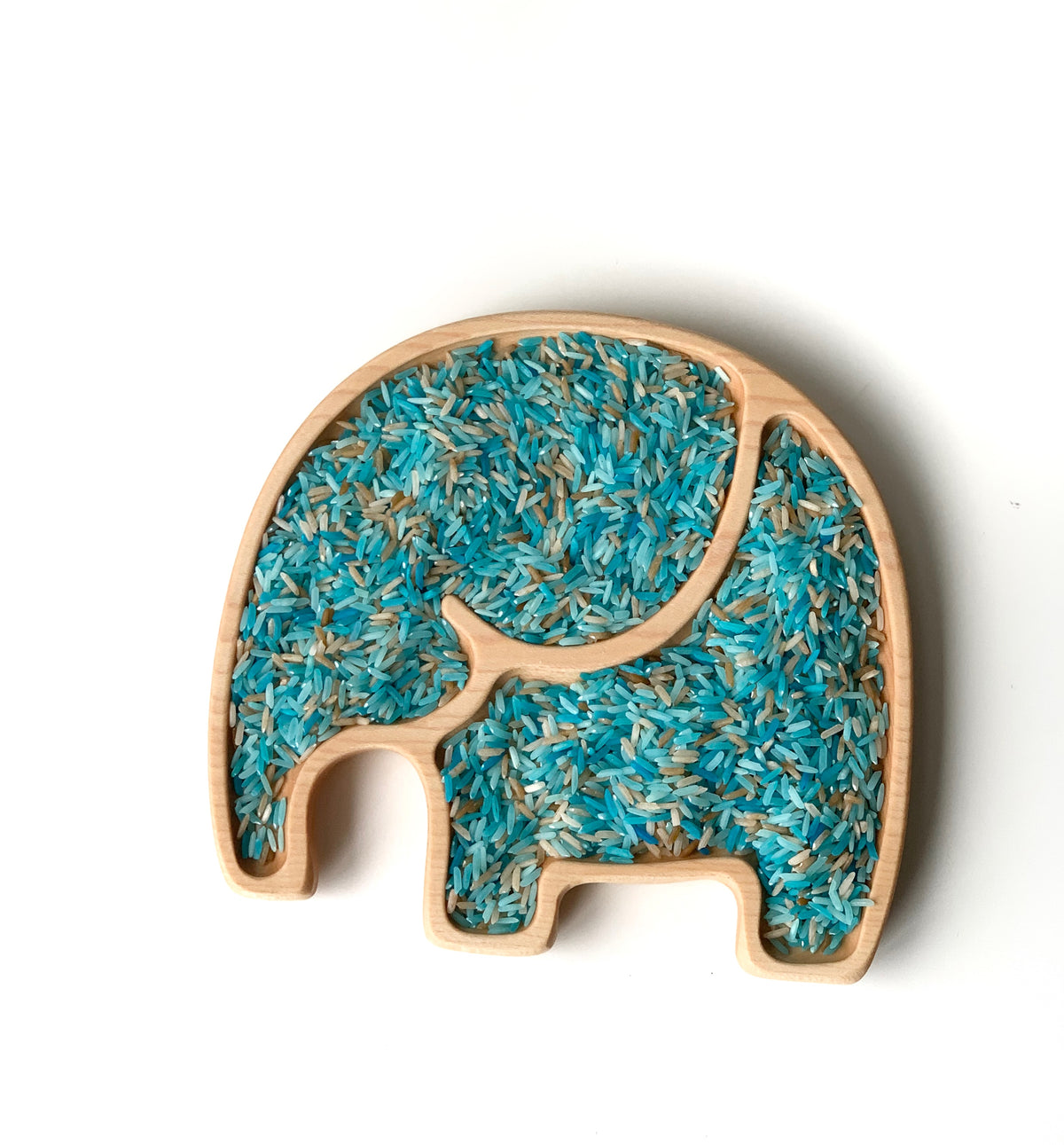 Elephant-shaped wooden sensory tray filled with blue, teal, and natural colored rice on white background