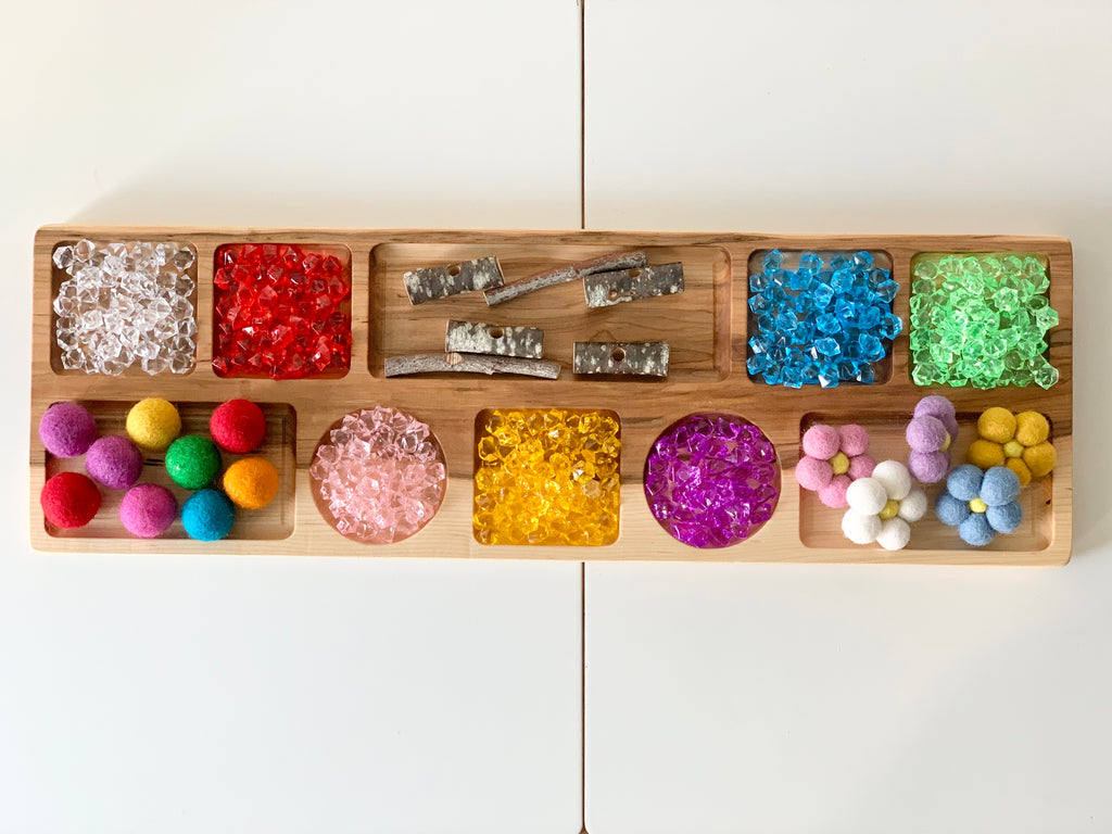 Extra large wooden tinker tray with colorful craft supplies including beads, pom-poms, and wooden sticks on white table