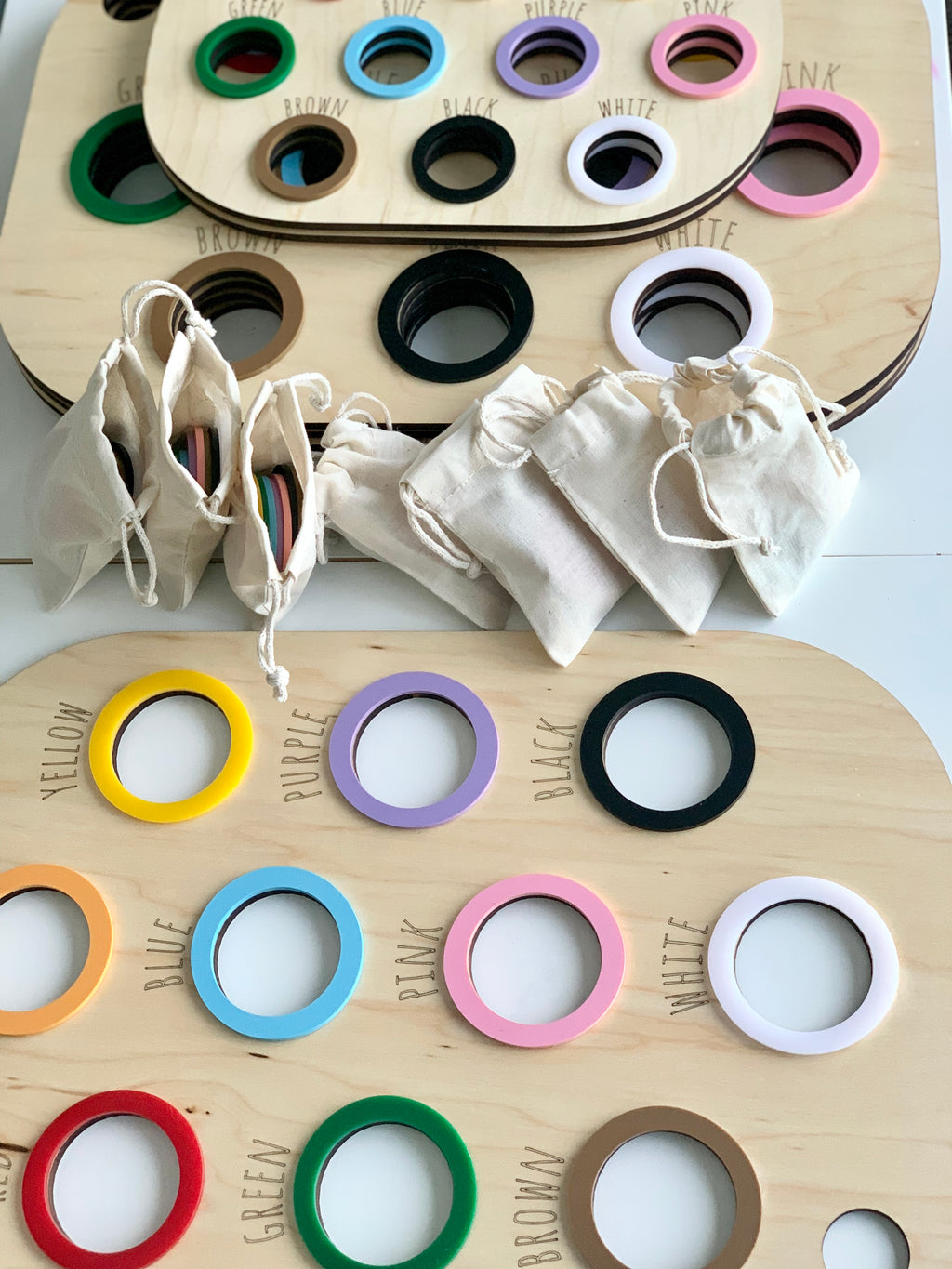 Maple plywood Colour Sorting Flisat Table Bin Lids with coloured rings and cloth pouches on white surface