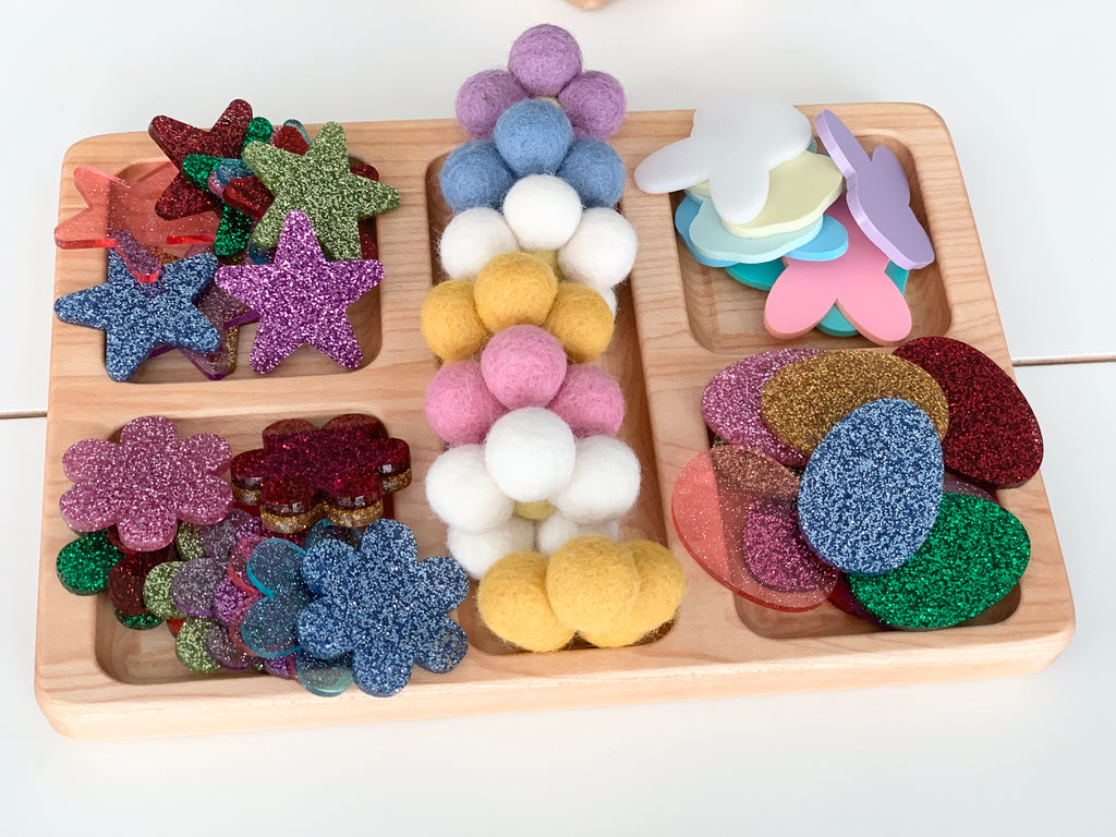 Wooden tray with laser cut acrylic shapes and colorful felt balls for sensory loose parts play set