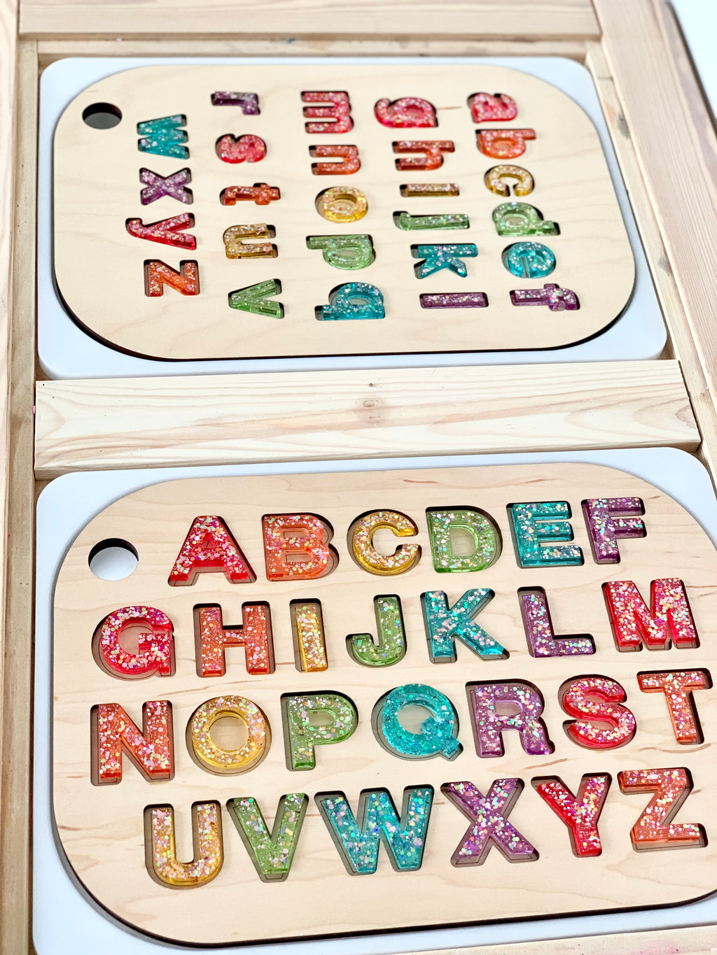 Wooden alphabet puzzle board with colorful resin uppercase and lowercase letters in a Flisat table top insert