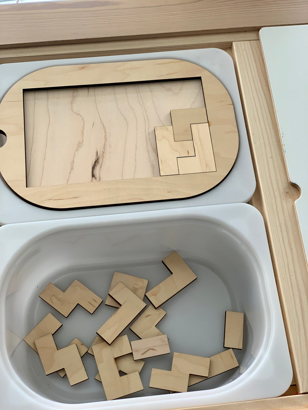Small wooden puzzle Flisat table top insert with interlocking pieces inside Trofast bin compartments