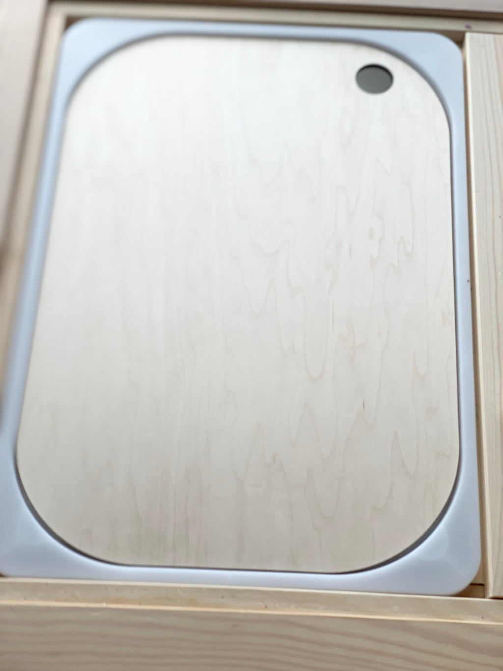 Natural wood Flisat table bin lid with smooth rounded corners and finger hole detail on light wood background