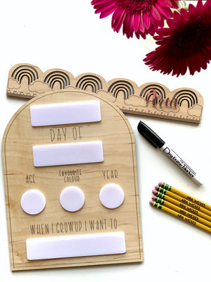 Wooden dry erase back to school sign with erasable name, age, color, year, and future aspirations sections on wood grain background