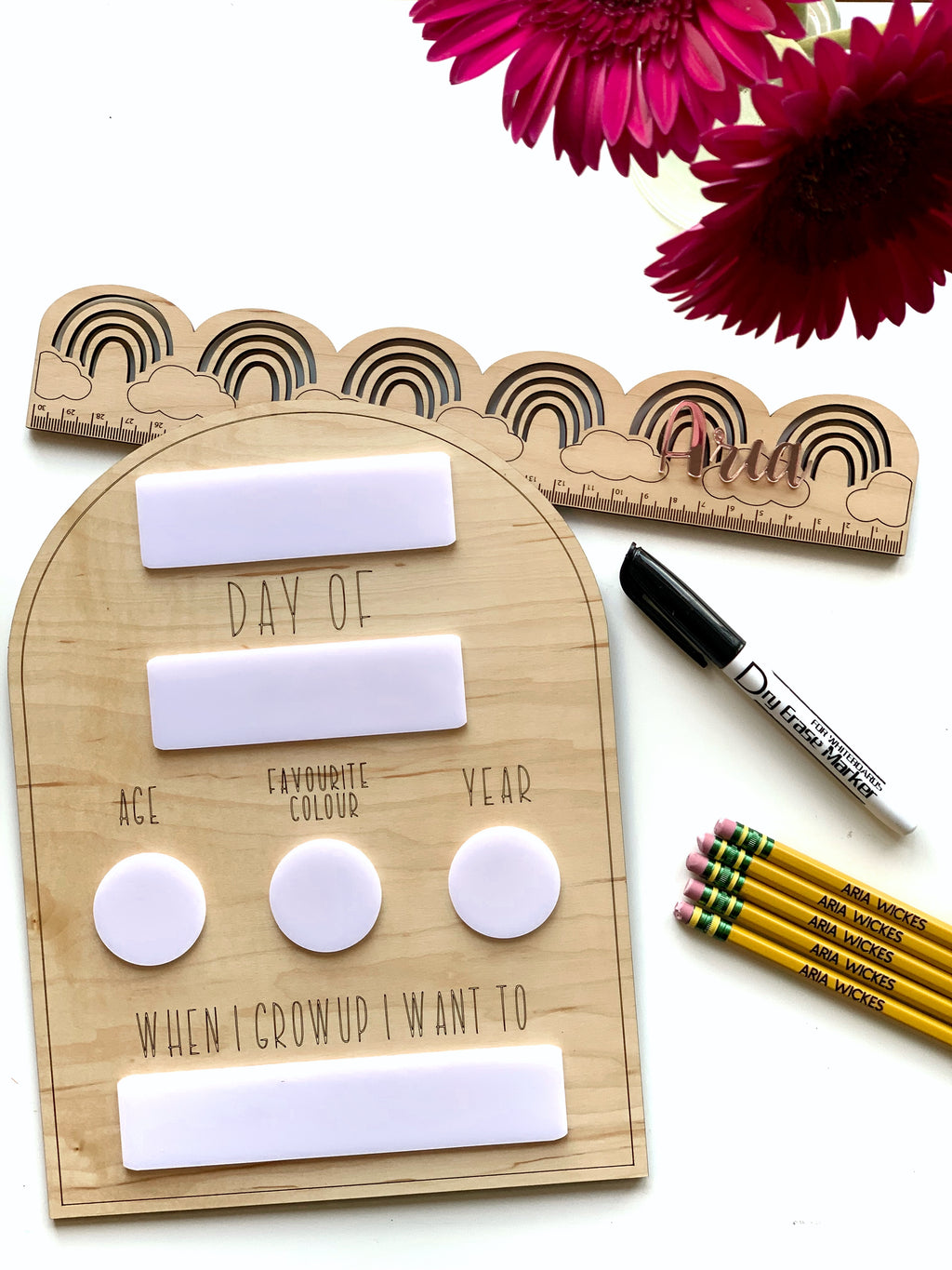 Wooden dry erase back to school sign with erasable name, age, color, year, and future aspirations sections on wood grain background