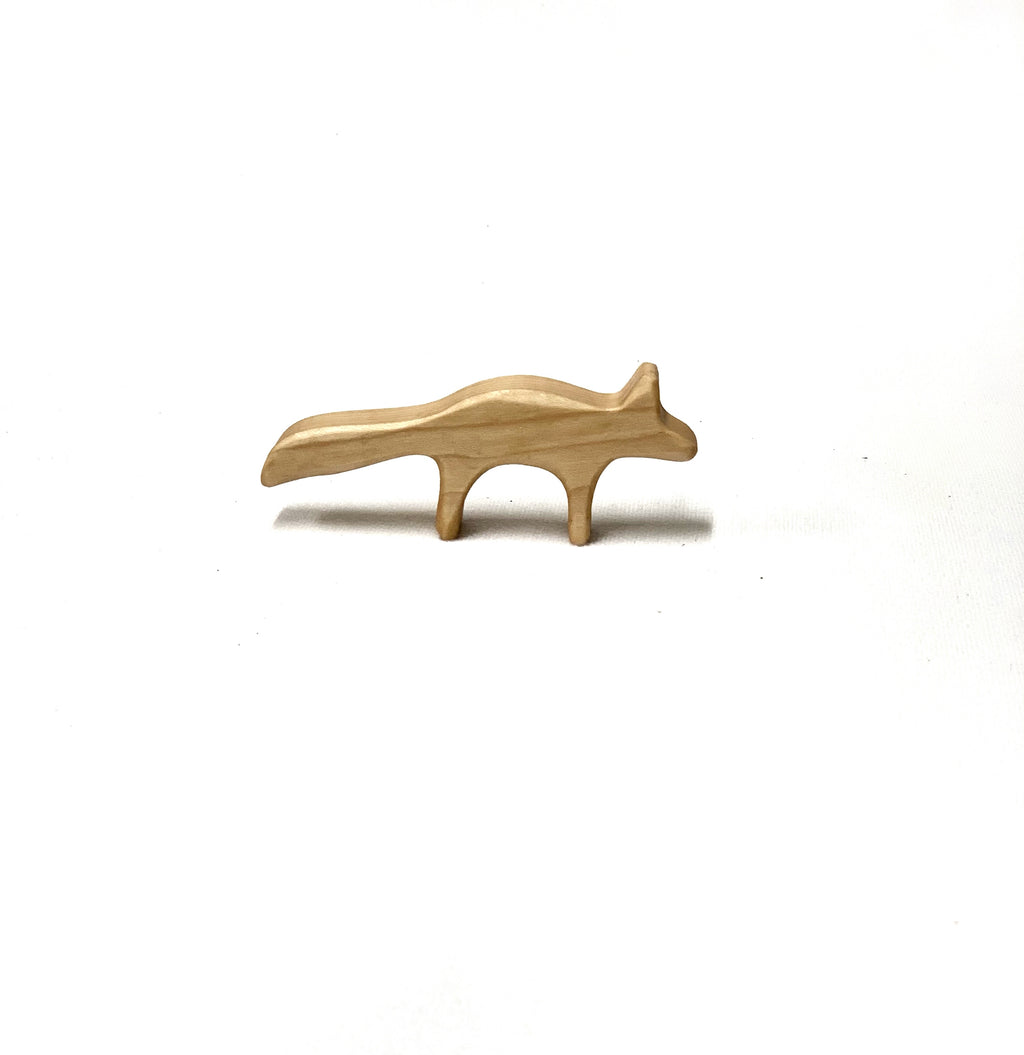 Small simple natural wooden fox figurine toy with smooth finish on white background