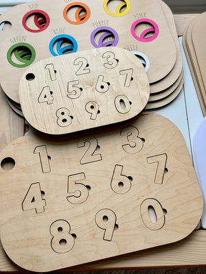 Natural maple plywood Number Puzzle Flisat table top inserts with engraved numbers 0 to 9 stacked on wooden surface
