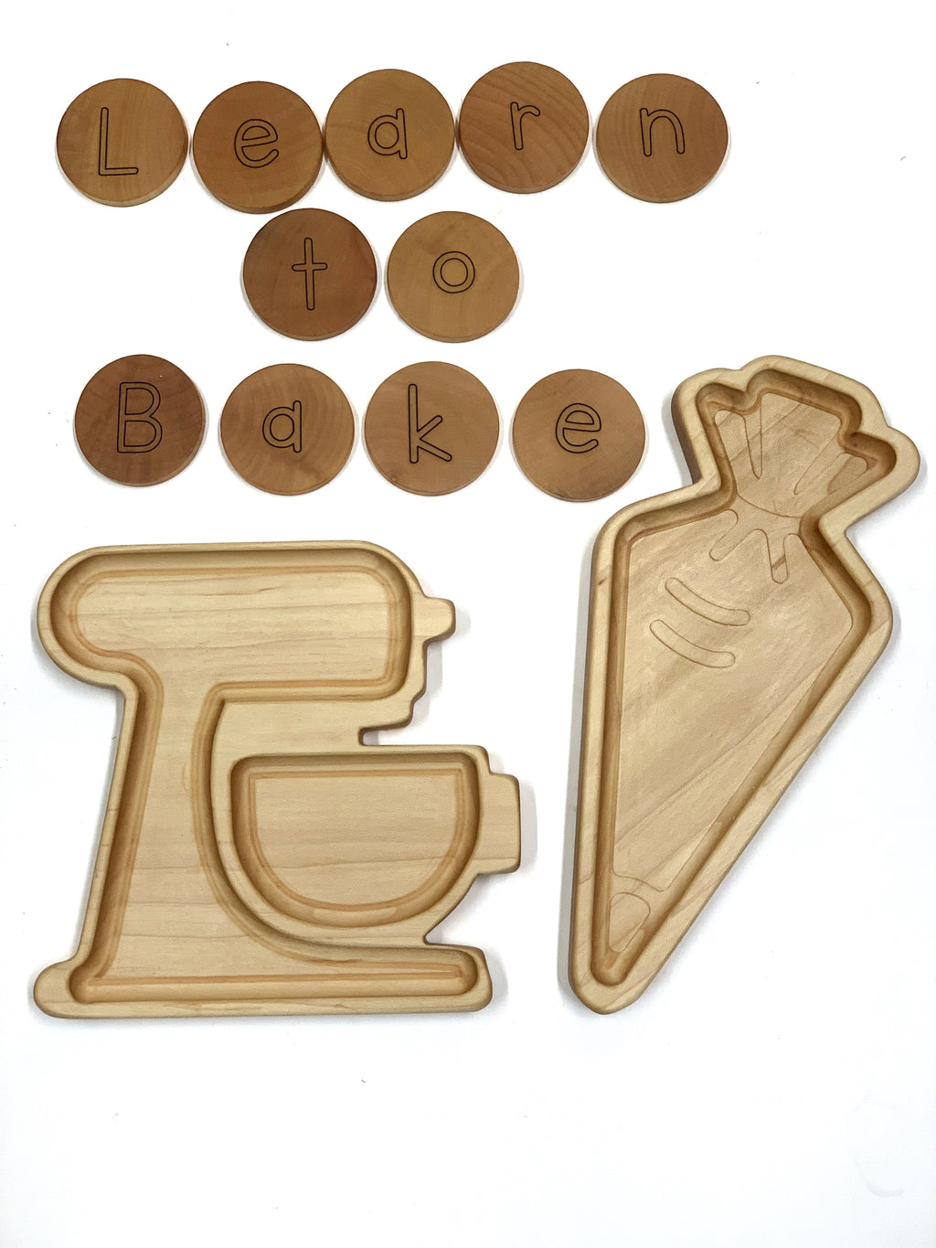 Wooden sensory tray shaped like a mixer and frosting bag with round wood letter tiles spelling Learn to Bake on white background