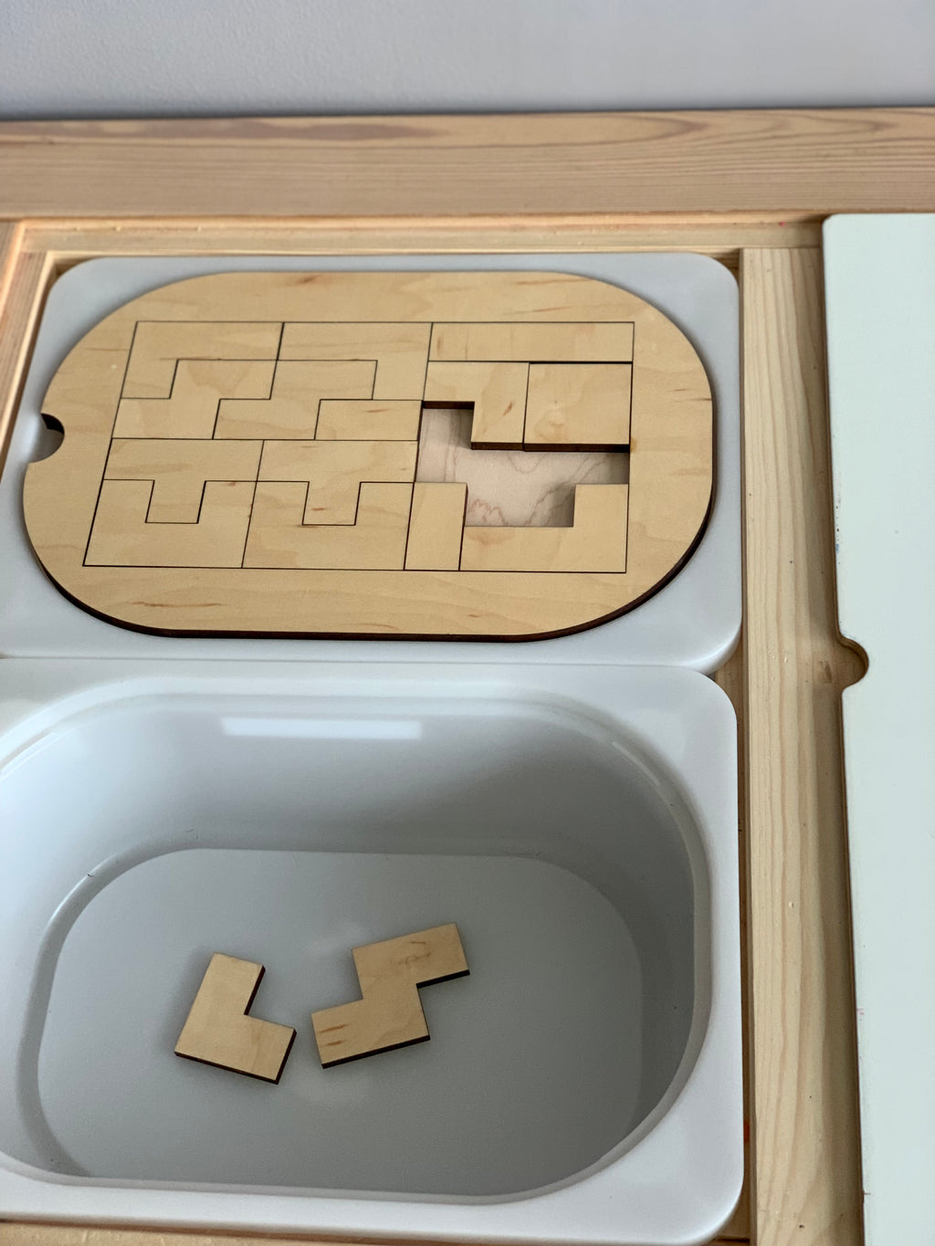 Small wooden puzzle Flisat table top insert with geometric pieces fitting into Trofast bin tray on light wood frame