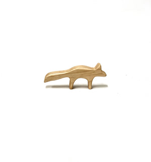Simple natural wooden fox figurine with smooth edges and minimalist design on white background