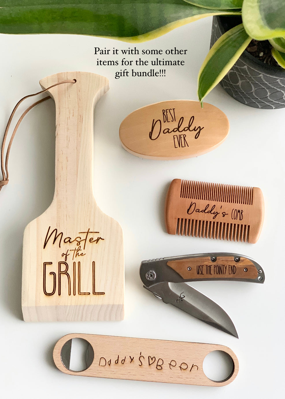 Custom wooden bottle opener with engraved "Daddy’s Beer" text paired with wooden grill spatula, comb, and knife accessories on white background