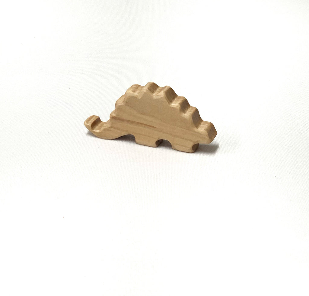 Small natural wooden dinosaur toy figurine with smooth edges on white background for imaginative play
