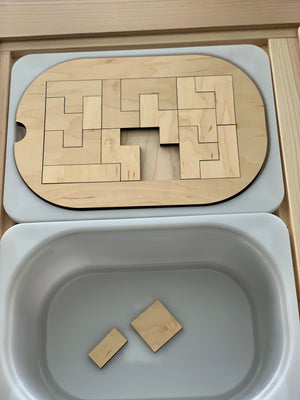Small wooden puzzle insert for Flisat bin with interlocking geometric pieces and natural wood finish