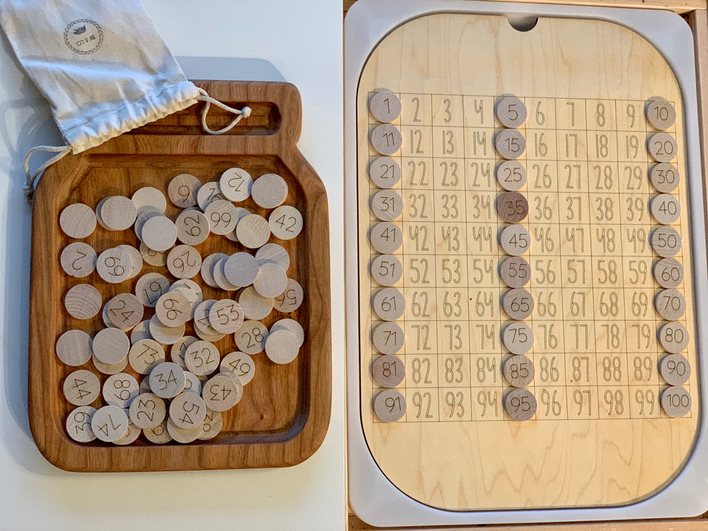 Maple wood 100 hundred frame board insert with numbered wooden discs and storage pouch on white surface