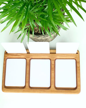Three section wooden tray with blank white flash cards and green potted plant on white background