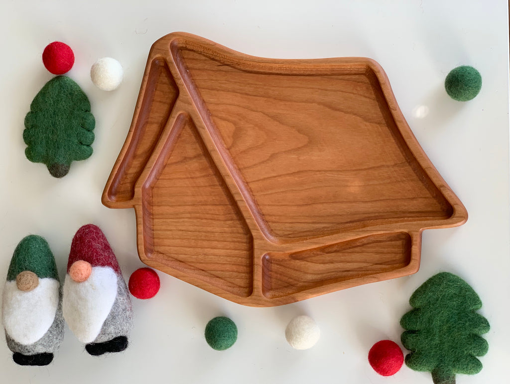 Whimsical 3D wooden house-shaped sensory tray with smooth natural wood grain surrounded by felt gnomes and trees decorations