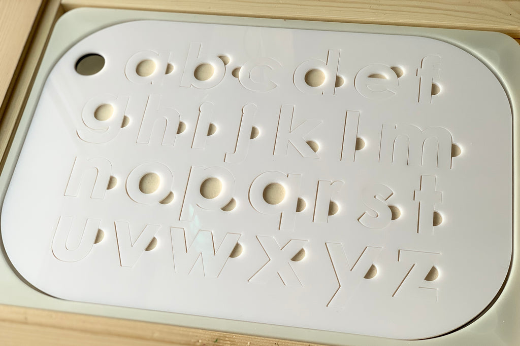 Lowercase alphabet puzzle insert with white acrylic letters on maple plywood base designed for Flisat table top bins