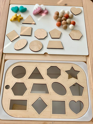 Wooden shape sorter Flisat table top insert with matching geometric pieces on light wood bin surface