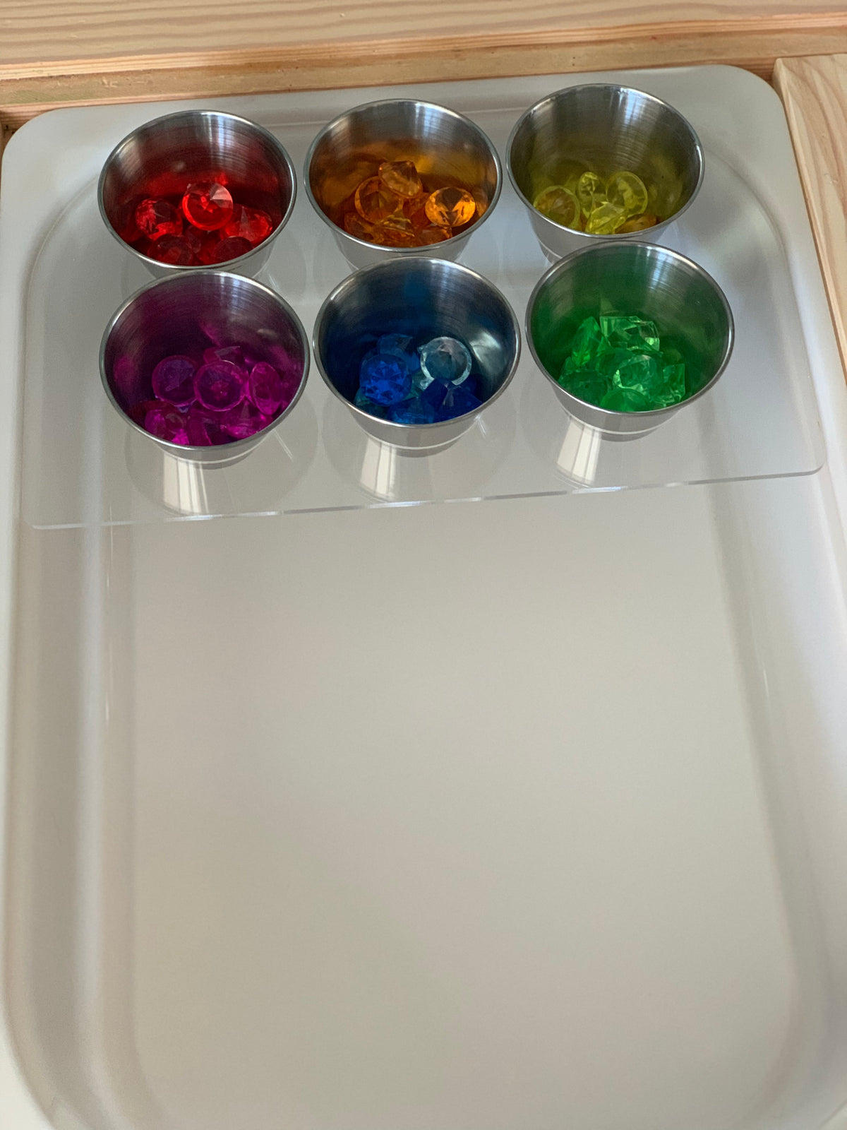 White half size Tinker Pot Flisat table top insert with six metal cups filled with colorful translucent sensory gems