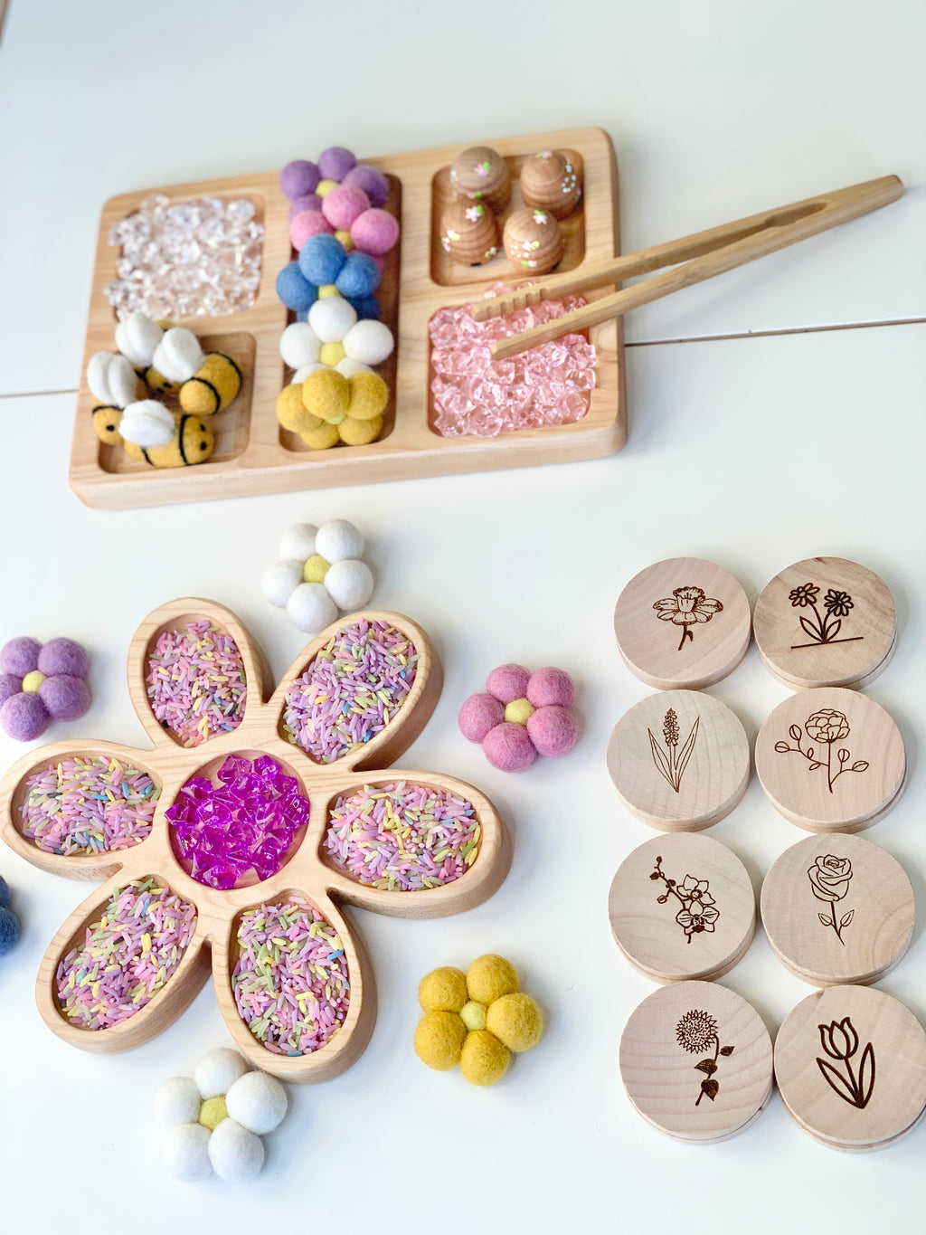 Natural wooden rectangle plate tinker tray with colorful felt balls, wooden tokens, and wooden flower-shaped tray with sensory fillers