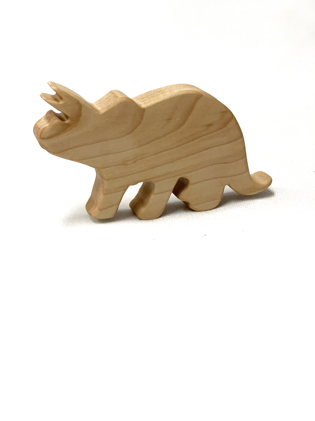 Natural wood Triceratops dinosaur toy figurine with smooth finish on white background for imaginative play