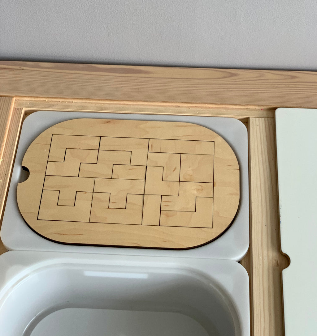 Small wooden puzzle insert with interlocking pieces designed to fit Trofast Flisat bins tabletop slot