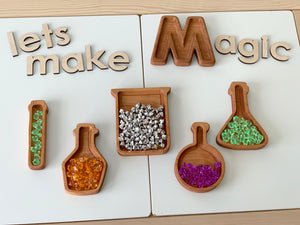 Wooden potion bottle plates shaped like science beakers filled with colorful translucent gems on white background