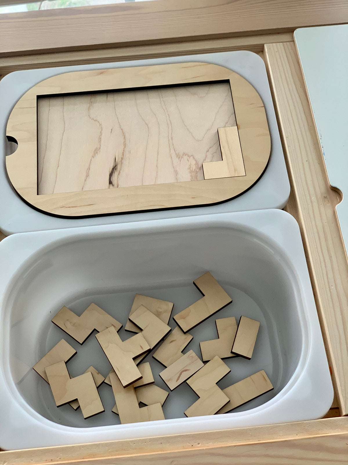 Small wooden puzzle Flisat table top insert with natural wood pieces inside white plastic bin tray