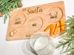 Personalized wooden Santa snack plate with engraved cookies, milk, and reindeer snacks sections on natural wood background
