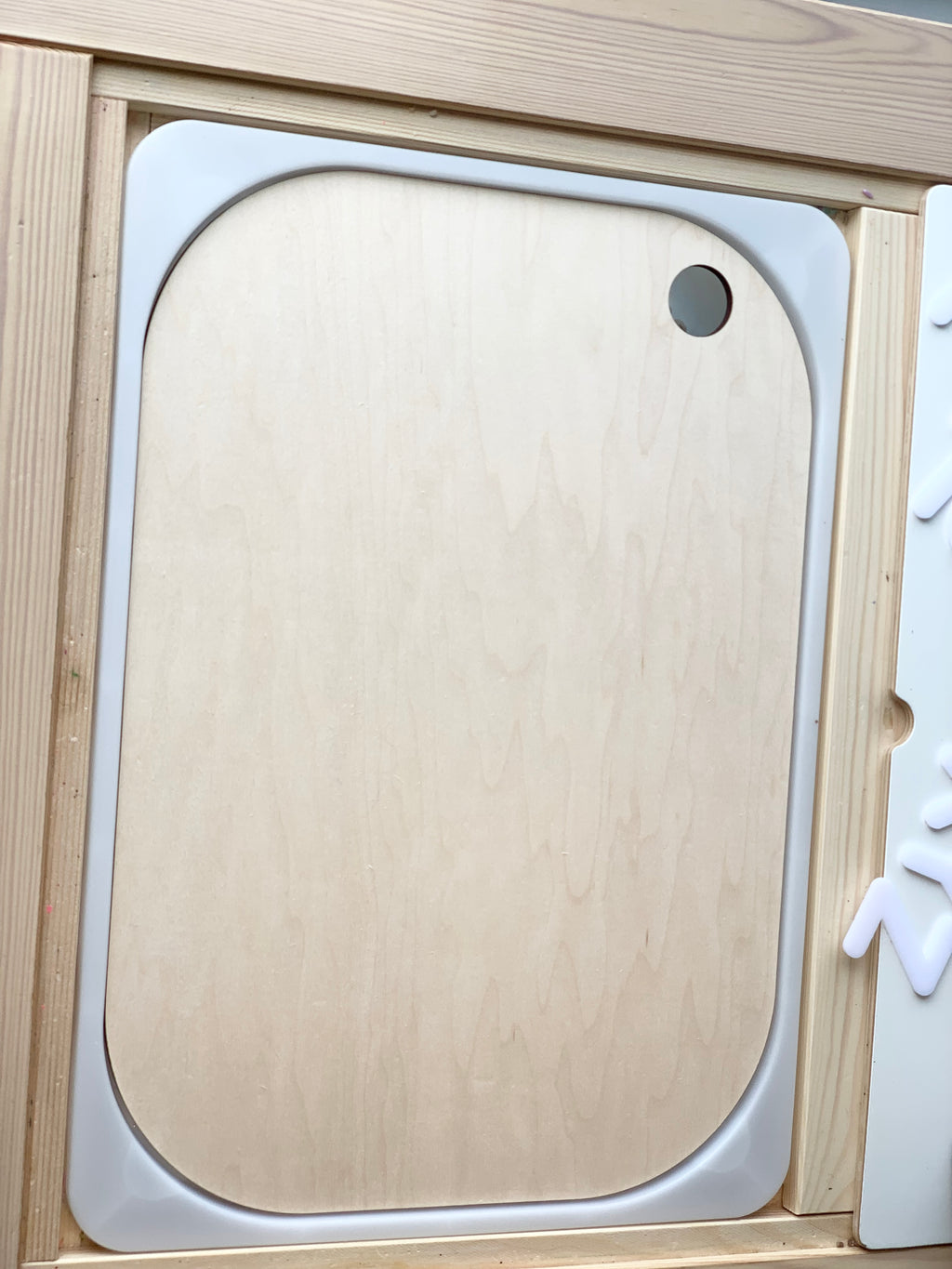 Natural maple plywood Flisat table bin lid insert with rounded corners and finger hole on wood frame background