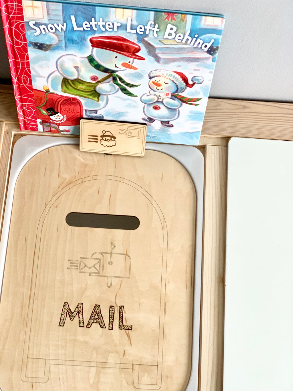 Maple plywood mailbox post box Flisat table top insert with engraved mail design and small letter prop on wooden surface next to book