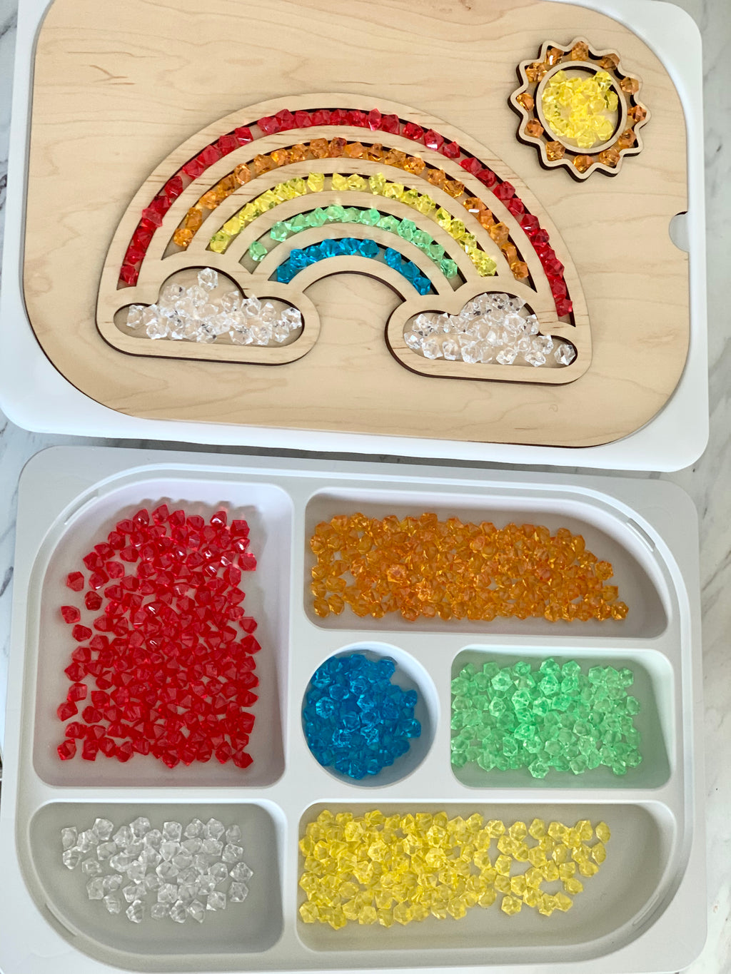 Wooden rainbow-shaped Flisat table top insert filled with colorful acrylic gems and separate storage tray with sorted gems