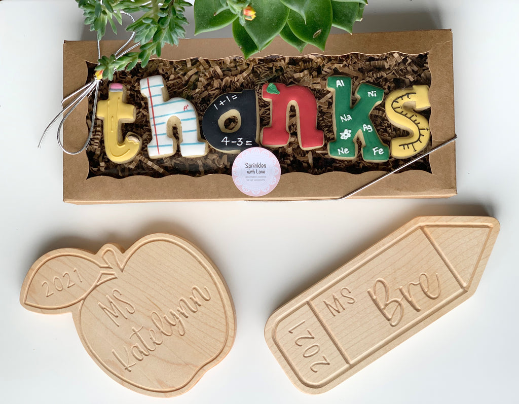 Personalized colorful wooden name sign with educational themed letters in box and engraved wooden apple and pencil plaques