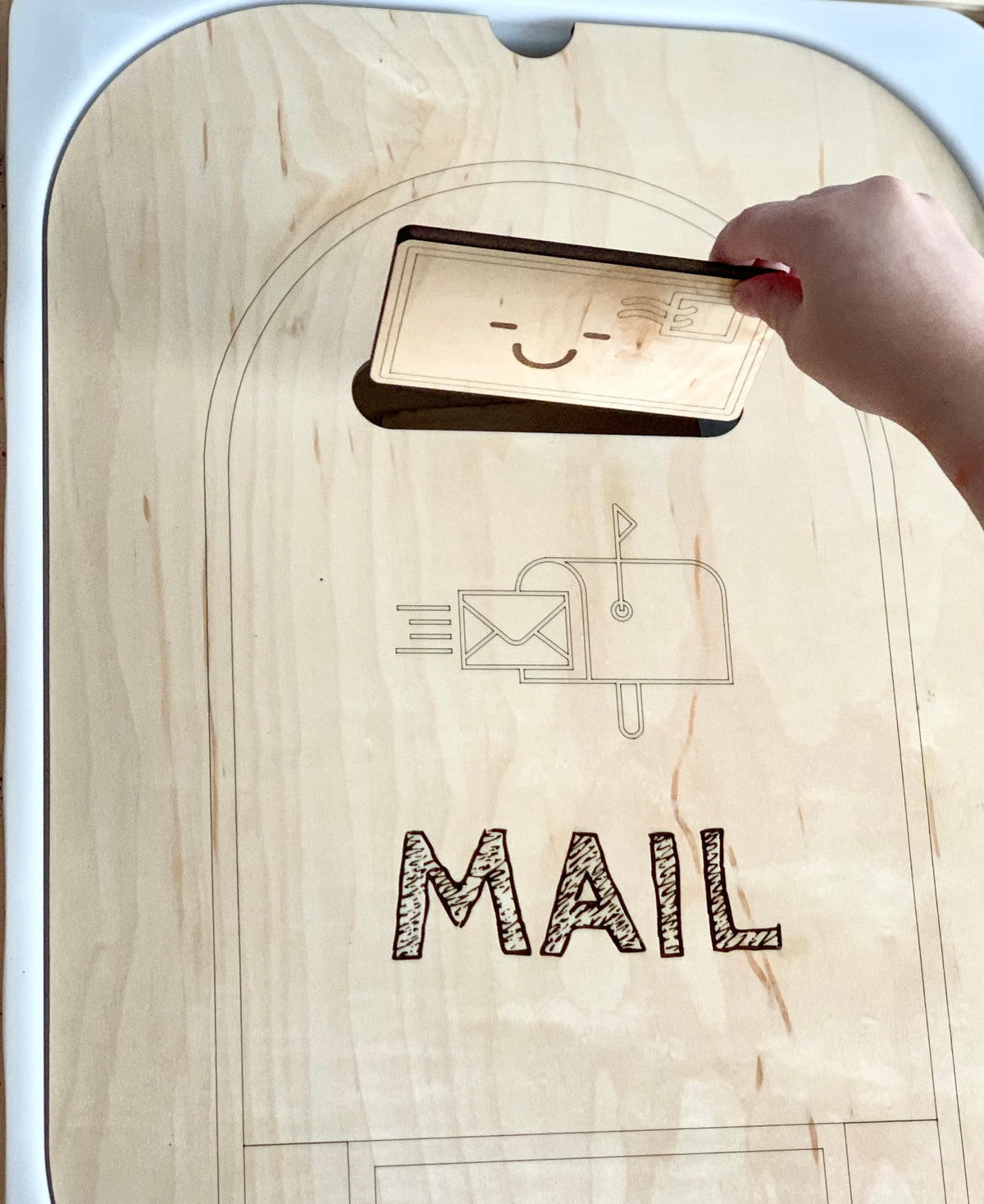 Maple plywood mailbox post box Flisat table top insert with engraved mailbox and MAIL text being used by hand inserting card