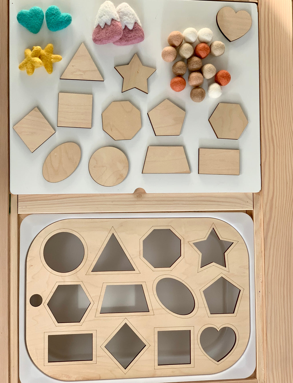 Wooden shape sorter Flisat table top insert with geometric shapes and colorful felt balls on wooden surface